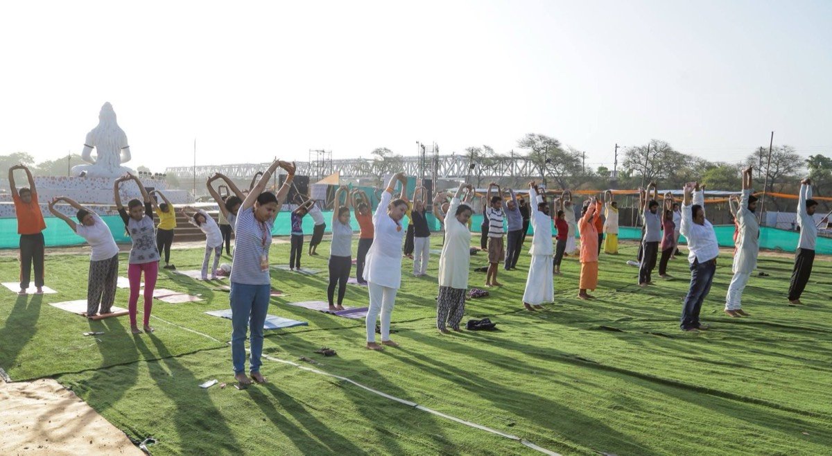 Group stretches at sunrise